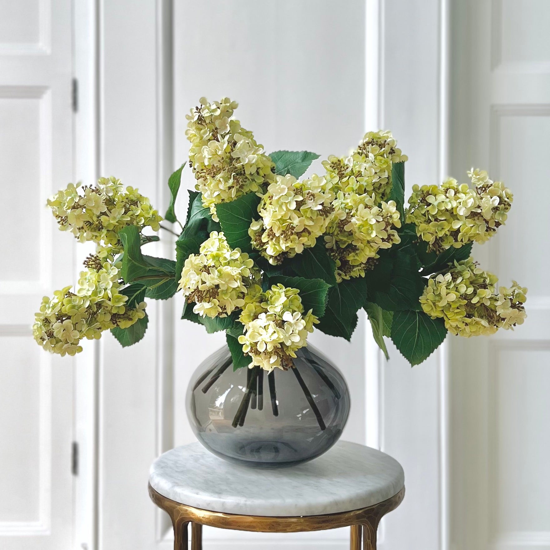 Luxury Lifelike Realistic Artificial Fabric Silk Luxury Flower Green Paniculata Hydrangea ABX5004GR Autumn Stem with Foliage in Smoky Grey Bulb Vase ABV0203 Buy Online from The Faux Flower Company